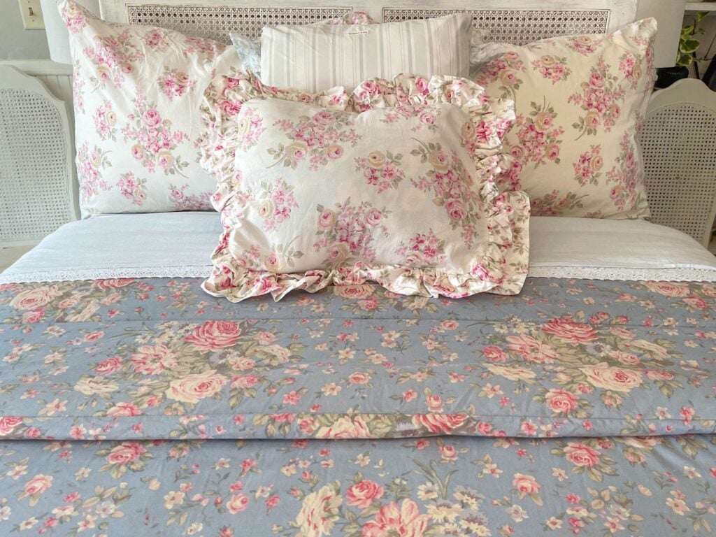 Medium shot of bed made with Ralph Lauren Shelter Island Blue queen comforter and matching pillows.