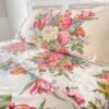 Side view of Ralph Lauren Melissa on White king pillowcase with pillow on the bed showing full floral design and half the bed neatly made