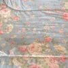 Top-down detail of Ralph Lauren Shelter Island Blue comforter showing floral motif and cotton texture.