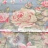 Top-down close-up of Ralph Lauren Shelter Island Blue comforter showing pink peonies and wildflowers on sky-blue background.