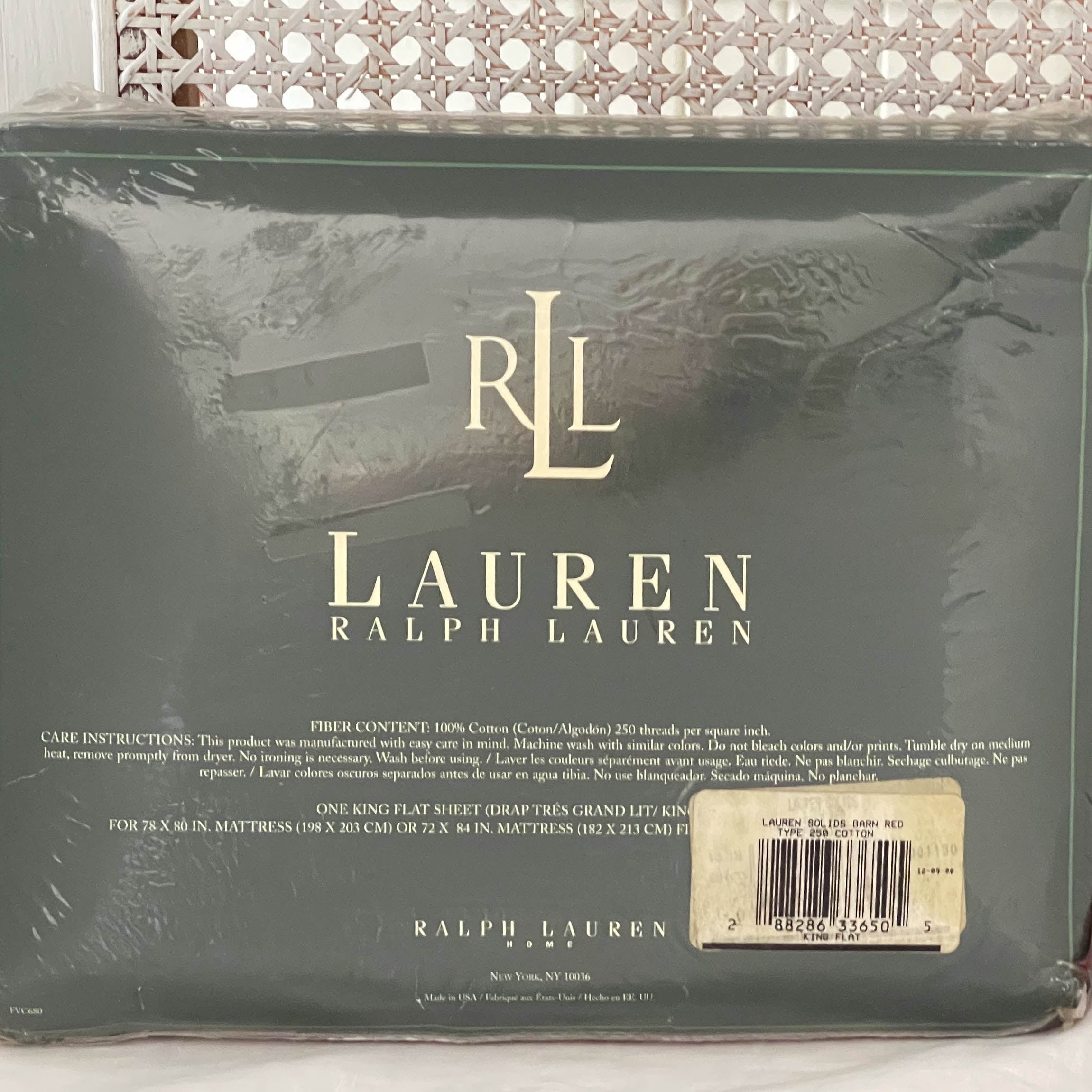 Close-up of the original packaging for the Ralph Lauren Lauren’s Solid barn red king flat sheet showing the barcode label with product details.