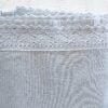 Close-up top-down view of Rachel Ashwell Simply Shabby Chic pale blue king flat sheet showing crochet trim detail along the top edge