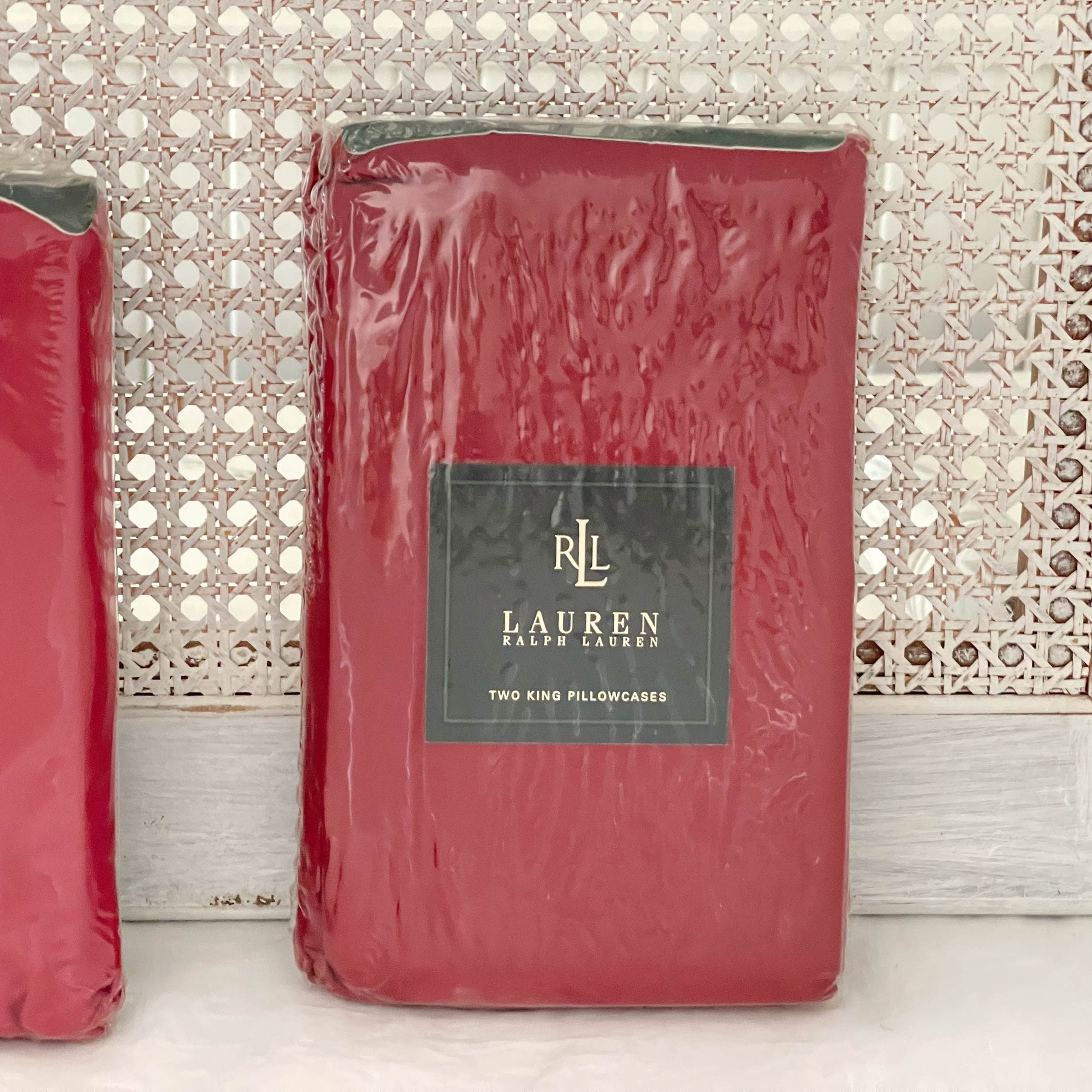 Front view of the Ralph Lauren Lauren’s Solid barn red king pillowcases in original packaging.