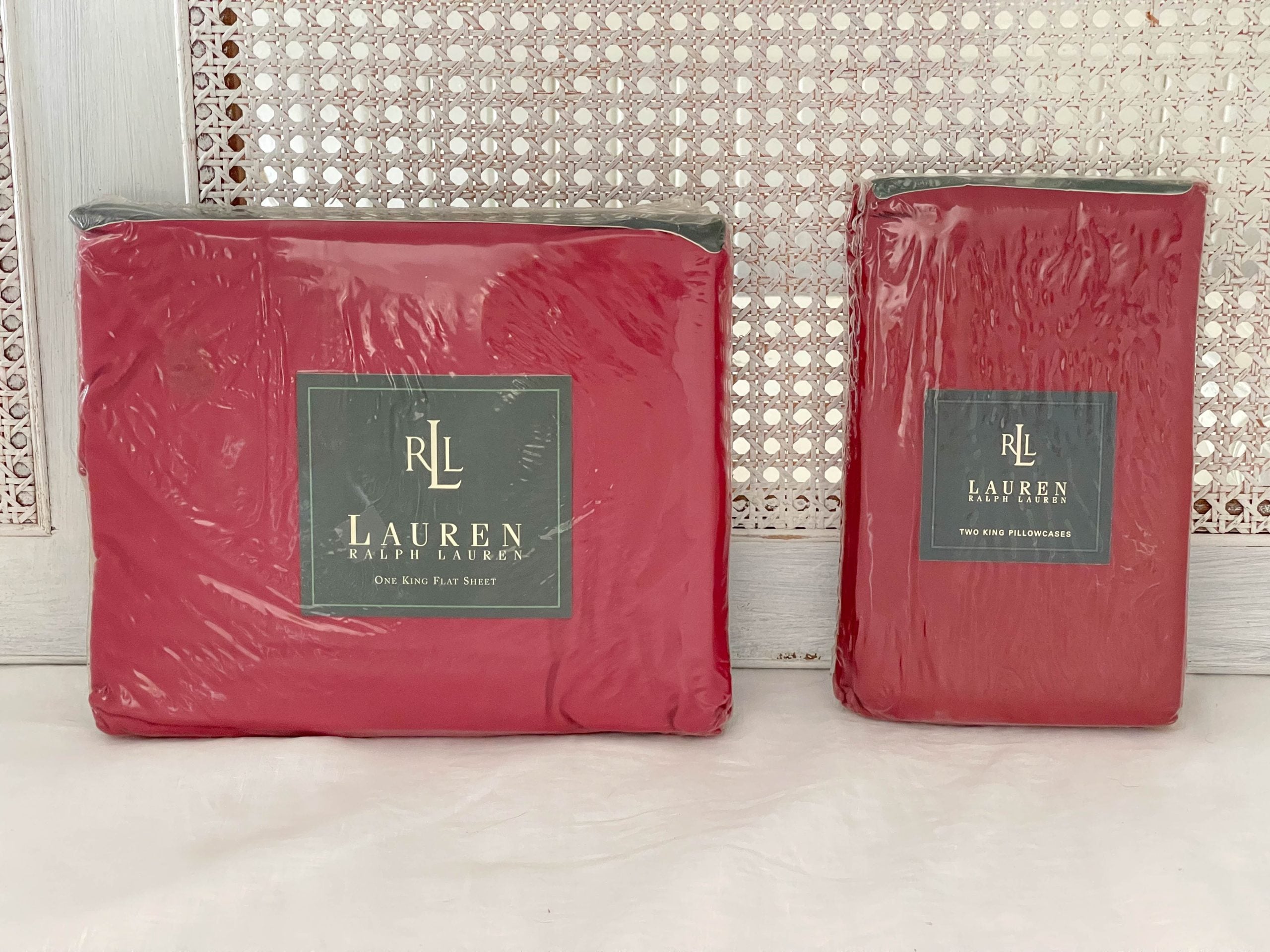 Ralph Lauren Lauren’s Solid barn red king flat sheet and two king pillowcases in original packaging, side view.