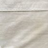 Top-down photo of a neatly folded Polo Ralph Lauren Estate Collection king flat sheet with the white Estate placard resting on top.