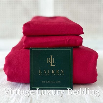 Ralph Lauren Barn Red sateen king fitted sheet neatly folded with two matching king pillowcases stacked on top; brand placard shown in front.