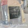 Side shot of the Ralph Lauren Chadwick Blue King Patchwork Quilt in its original packaging with the Ralph Lauren placard in front