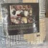 Medium shot of the back of the original packaging for the Ralph Lauren Chadwick Blue Patchwork Quilt showing the 1990s insert image of the quilt styled on a bed