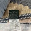 Close-up of the navy Ralph Lauren tag sewn into the seam of the Chadwick Blue Patchwork King Quilt