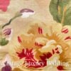 Close-up of the Constance floral pattern showing bright red peonies with gold edges, lavender and pink wildflowers, blue accents, and green leaves on a beige ground.