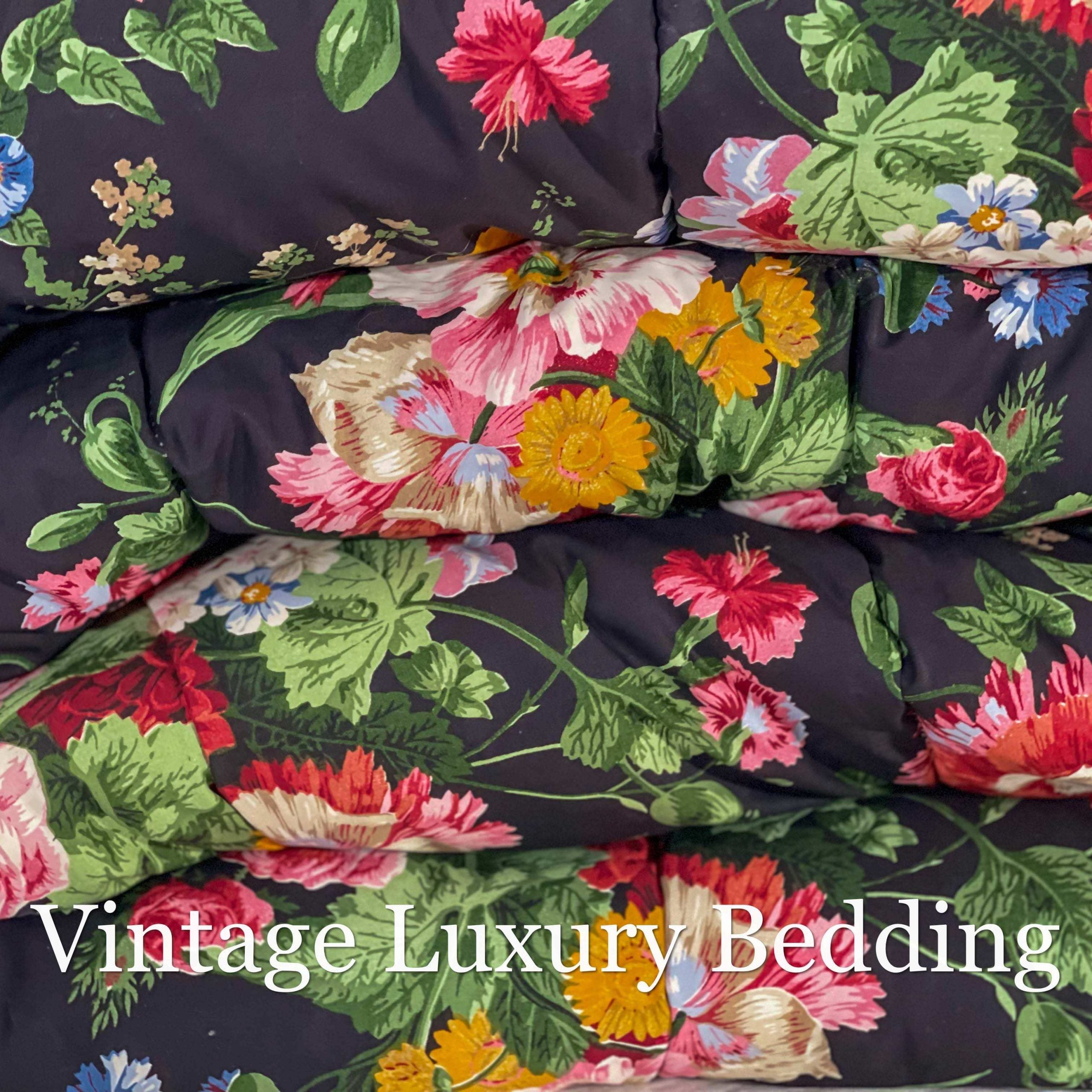 Top-down close-up of the rare retired Ralph Lauren Isadora Collection Cossette Floral king comforter from the Ralph Lauren Home line, showing bright pink, red, and white peonies and roses with blue, pink, orange, white, and lavender wildflowers on a deep black background.