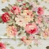 Top-down close-up of the gorgeous floral pattern on the rare retired Ralph Lauren Stone Harbor king comforter, showing pink, white, and pale yellow peonies with light blue, lavender, and white wildflowers on a pale aqua background.