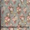 Medium top-down shot of the rare retired Ralph Lauren Charlotte comforter from the Ralph Lauren Home line, showing the repeating floral pattern and the top stitching on the sage green background.