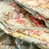 Side shot of the rare retired Ralph Lauren Charlotte comforter from the Ralph Lauren Home line, showing the folded edge and a clear view of the floral pattern with light red ranunculus, roses, peonies, and multicolored wildflowers on a sage green background.