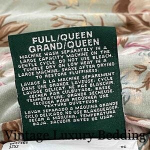 Very tight close-up of the back of the tag on the rare retired Ralph Lauren Charlotte queen comforter from the Ralph Lauren Home line, showing the size, QUEEN marking, and washing instructions.