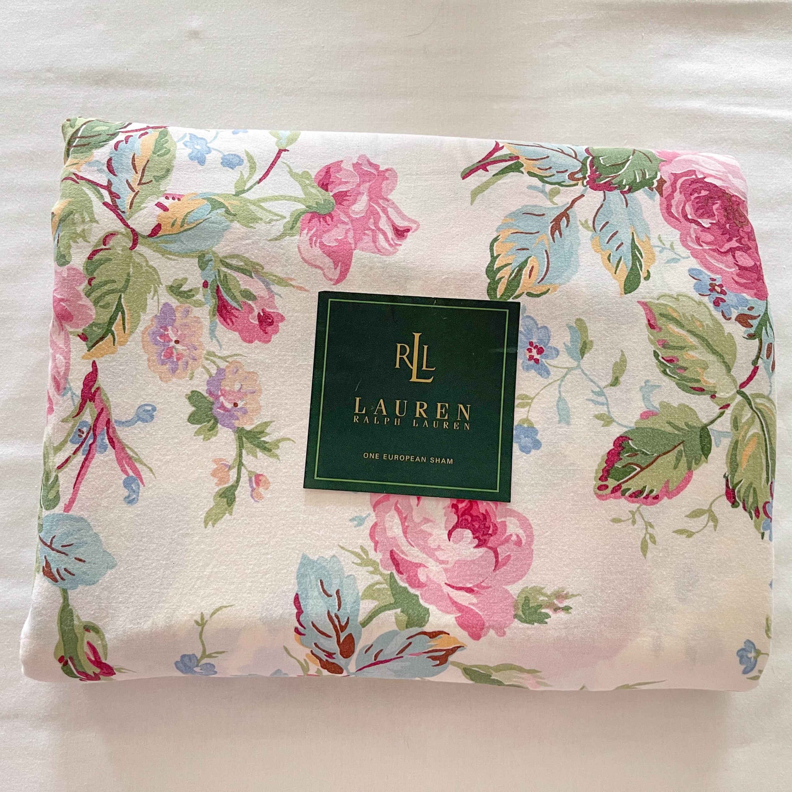 Top-down photo of folded fitted sheet from Ralph Lauren Water Floral Pink set with placard