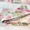 Side-angle view of folded vintage Ralph Lauren sheet showing Water Floral Pink design with peonies and wildflowers