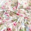 Overhead view of delicately rumpled vintage Ralph Lauren floral sheet from the Water Floral Pink collection