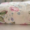 Side view of folded vintage Ralph LaurenWater Floral Pink King fitted sheet with floral print