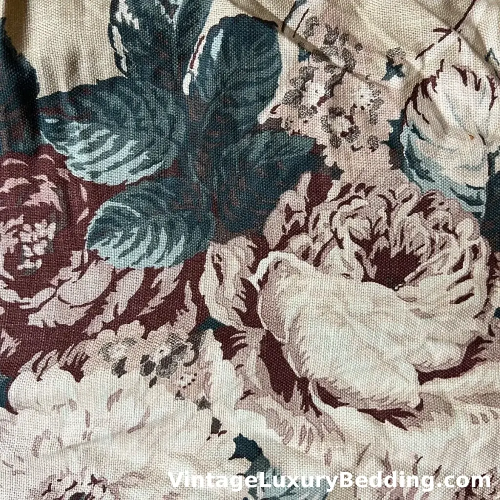 Ralph Lauren Bucks County Floral swatch with oversized burgundy and ivory blooms on a natural linen-colored background, accented by sage and slate green leaves