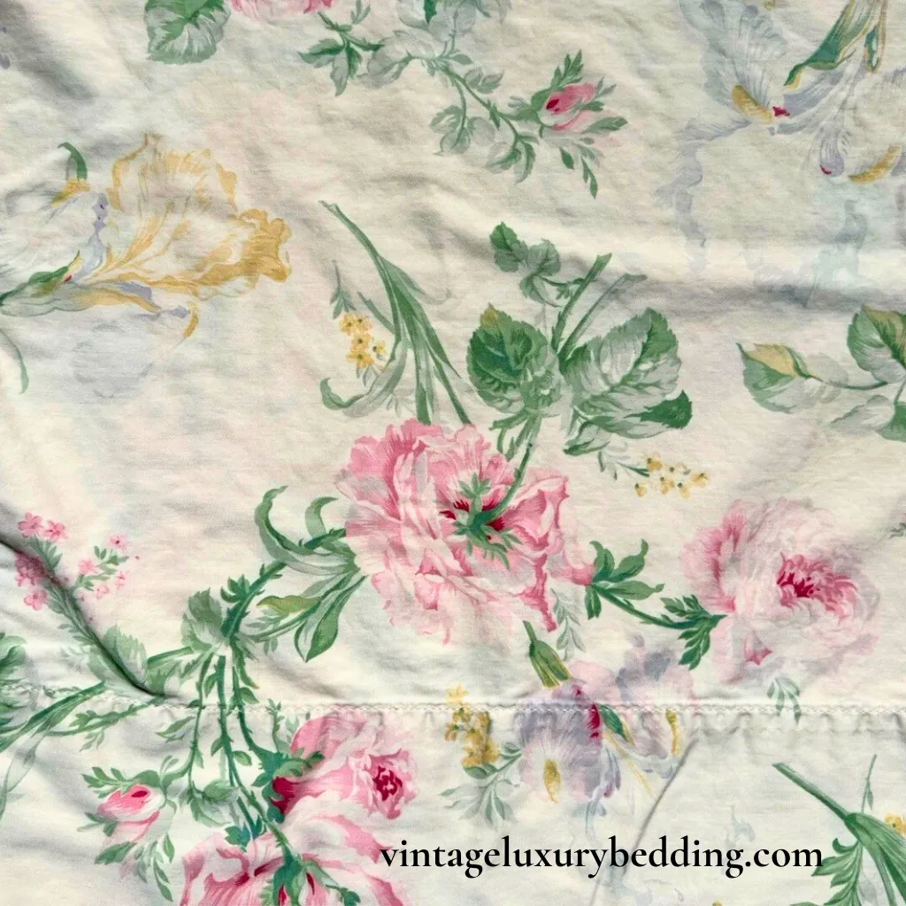 Ralph Lauren Therese bedding swatch with watercolor-style florals in pink, yellow, and lavender on a soft ivory background
