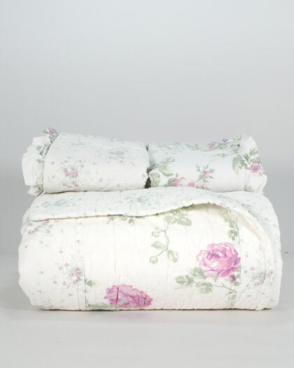 Simply Shabby Chic lavender top-stitched reversible quilt nearly folded and stacked with matching shams on top