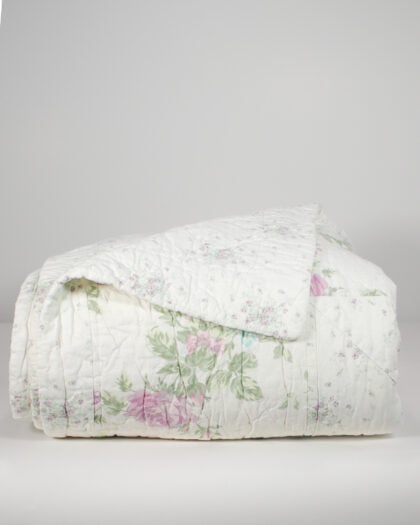 Front view of nearly folded Simply Shabby Chic lavender top-stitched reversible quilt showing lavender floral pattern