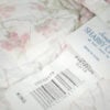 Close-up of Simply Shabby Chic tag on pink top-stitched king quilt showing Q3 2018 and Target RN code