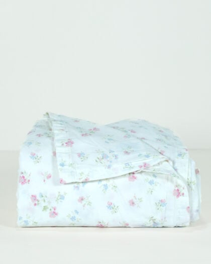 Side view of a Simply Shabby Chic Target-era Candy Cane Floral full flat sheet in cotton with a white background and soft pink and blue floral print