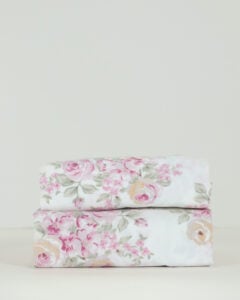 Front view of a neatly stacked pair of Simply Shabby Chic Blush Beauty 31 by 56 inch valances