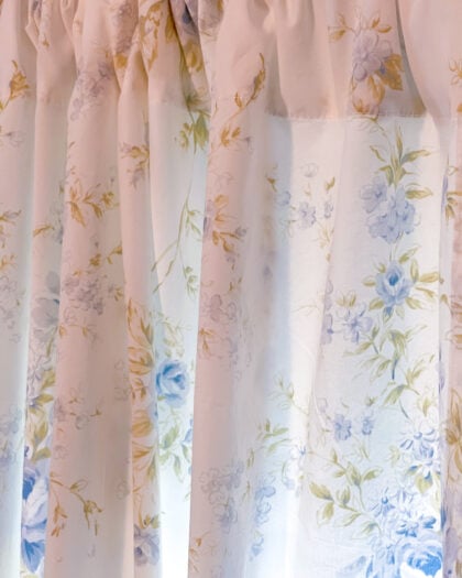Medium view of Simply Shabby Chic British Rose curtain panels hanging on rods at a window with soft blue floral print on white