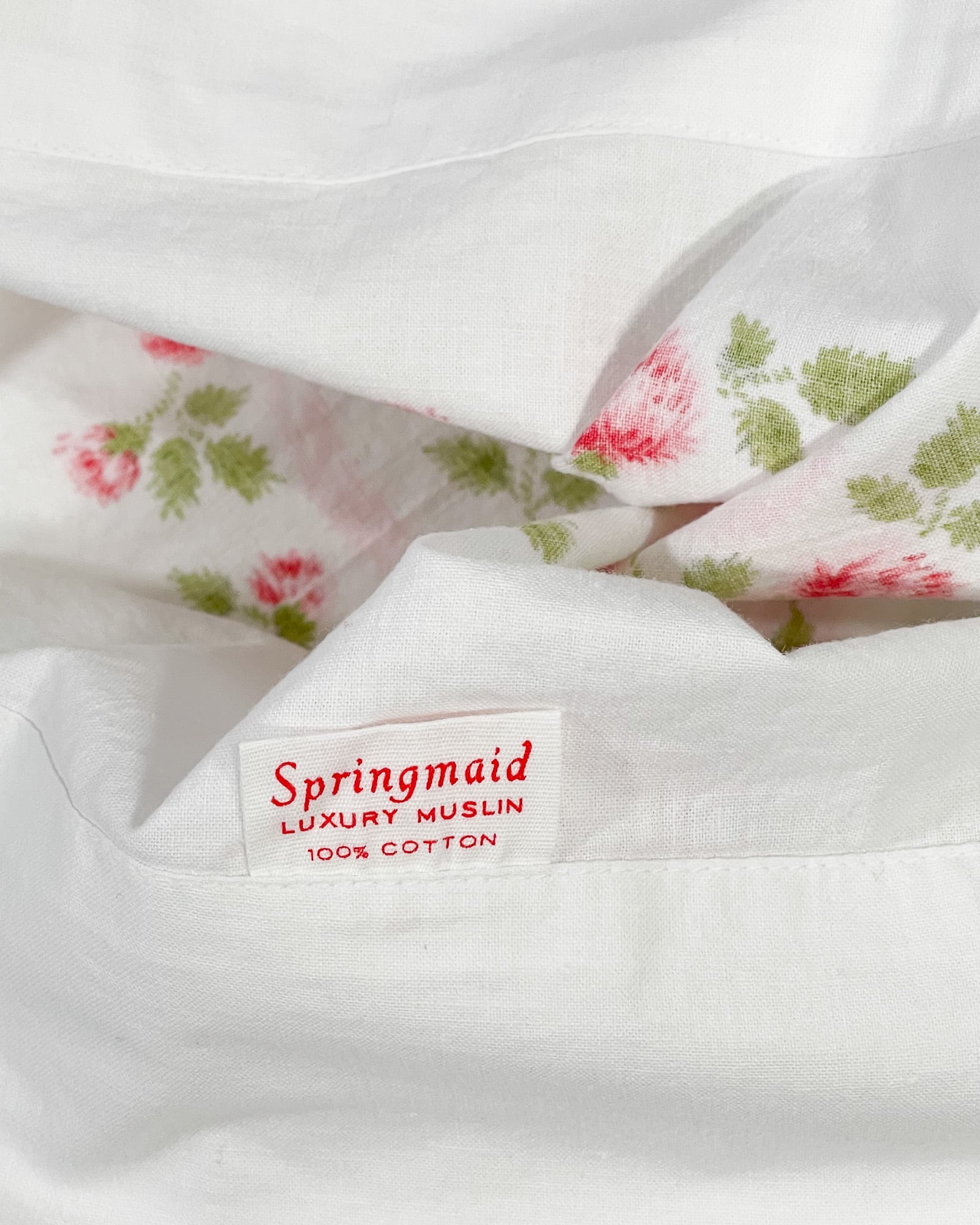 Close-up of Springmaid Luxury Muslin tag showing 100 percent cotton