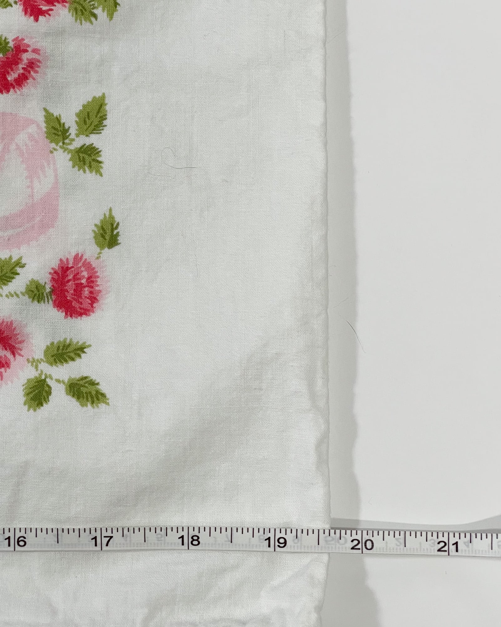 Vintage Springmaid Muslin pillowcase shown with measuring tape indicating 20 inch width