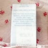 Close-up of Simply Shabby Chic care tag showing 100 percent cotton and washing instructions