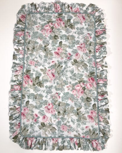 Full top-down view of Laura Ashley Cottage Rose ruffled sham with pink floral print and ruffled border
