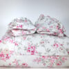 Simply Shabby Chic Blush Beauty queen duvet neatly folded with matching ruffled shams stacked front view