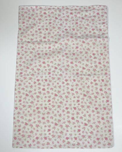 Full flat lay of vintage white cotton standard pillowcase with soft pink ditsy rose pattern
