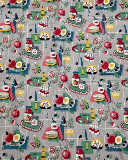 Overall view of vintage 1950s post-war kitchen novelty print cotton fabric with colorful food-themed motif