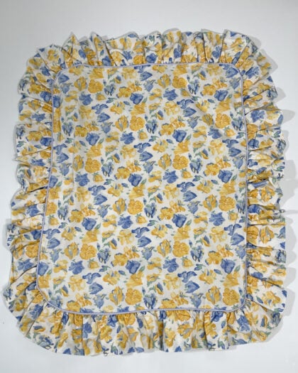 Full top-down view of Laura Ashley Charlotte Confetti ruffled sham with yellow and blue floral print