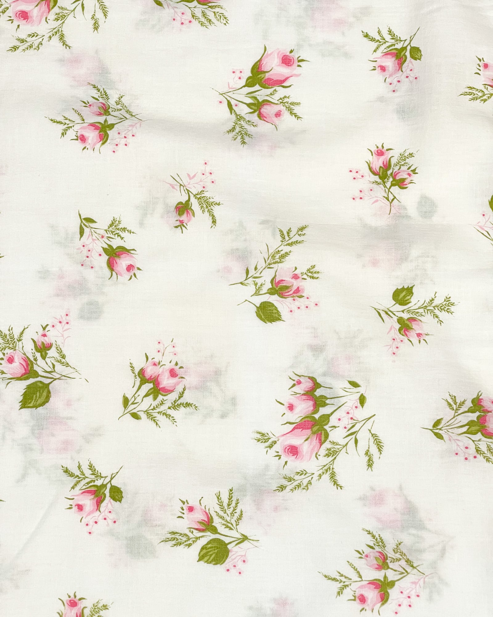 Wide pattern view of vintage pillowcase with pink rosebud clusters on white cotton