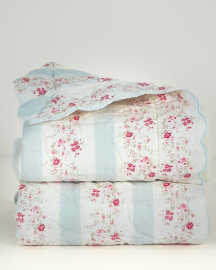 Pair of folded Simply Shabby Chic Blush Beauty quilted shams with soft blue stripes and blush floral sprigs