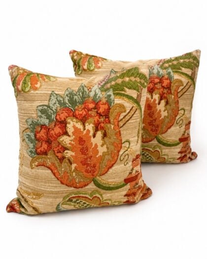 Pair of vintage Schumacher Aragon designer throw pillows featuring ornate floral botanical fabric in coral, sage, and warm neutral tones