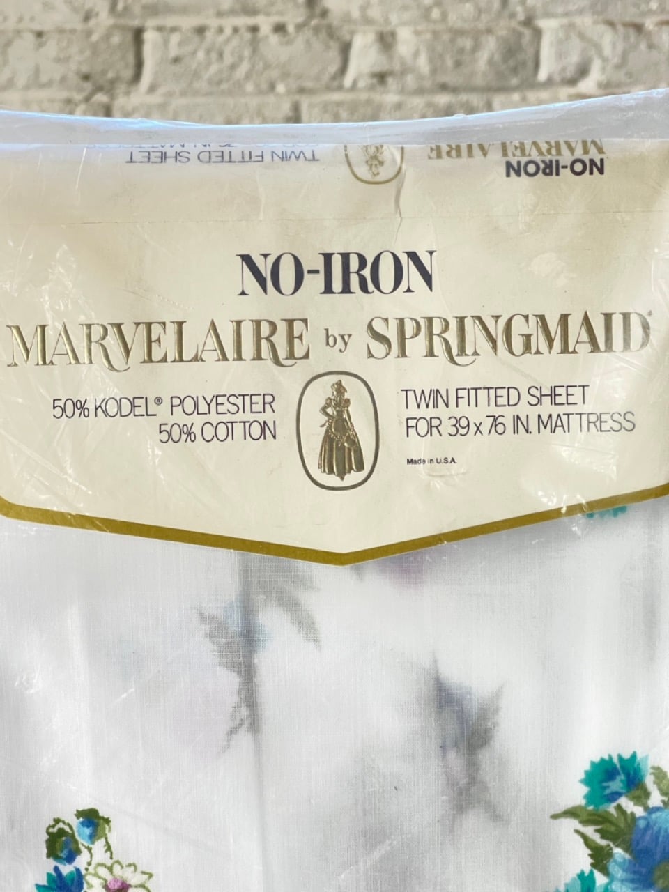 Marvelaire by Springmaid package label above blue floral twin fitted sheet